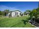 The home's exterior featuring a well-maintained lawn and tropical landscaping at 9350 Prospect Ave, Englewood, FL 34224