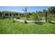 Well-manicured front yard with lush grass, tropical plants, and a stone walkway at 9350 Prospect Ave, Englewood, FL 34224