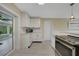 Bright kitchen featuring white cabinetry, sleek countertops, and modern stainless steel appliances at 9350 Prospect Ave, Englewood, FL 34224