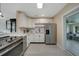 Modern kitchen with white cabinets, stainless steel appliances, and light countertops at 9350 Prospect Ave, Englewood, FL 34224