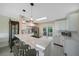 Open kitchen with white cabinets, sleek countertop island and pendant lighting creating a cozy space at 9350 Prospect Ave, Englewood, FL 34224
