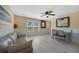 Cozy living space with neutral paint, wood-look floors, and a comfortable sofa near a window at 9350 Prospect Ave, Englewood, FL 34224
