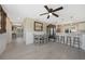 Bright living space with wood-look tile floors, ceiling fan, and a dining area with natural light at 9350 Prospect Ave, Englewood, FL 34224