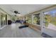 Bright sunroom with wood accents, ceiling fans, exercise equipment, and plenty of windows to enjoy the backyard views at 9350 Prospect Ave, Englewood, FL 34224