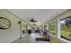Bright sunroom with wood accents, ceiling fans, exercise equipment, and plenty of windows to enjoy the backyard views at 9350 Prospect Ave, Englewood, FL 34224