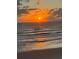 Beautiful sunset over the ocean with golden light reflecting on the waves and wet sand at 9350 Prospect Ave, Englewood, FL 34224