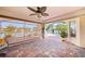 Screened lanai with brick pavers and ceiling fan overlooking lush landscaping and swimming pool at 98 Seasons Dr, Punta Gorda, FL 33983