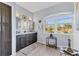 Elegant bathroom with dual sinks, wooden cabinets, and a large window providing natural light and exterior views at 10082 Army Cir, Port Charlotte, FL 33981
