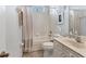 Cozy bathroom featuring a combined shower-tub, vanity, and white tiling at 10082 Army Cir, Port Charlotte, FL 33981