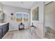 Bright bathroom featuring a large window, double vanity, walk-in shower, and tile flooring at 10082 Army Cir, Port Charlotte, FL 33981