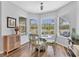 Charming breakfast nook features a glass table, cushioned seating, and large windows offering exterior views at 10082 Army Cir, Port Charlotte, FL 33981