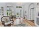 Bright foyer with hardwood floors, chandelier, and arched doorway at 10082 Army Cir, Port Charlotte, FL 33981