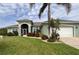 Charming single-story home boasts lush landscaping, a well-manicured lawn, and inviting curb appeal at 10082 Army Cir, Port Charlotte, FL 33981