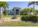 Landscaped front yard with palm trees and lush green lawn at 10082 Army Cir, Port Charlotte, FL 33981