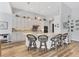 Spacious kitchen with white cabinets, granite countertops, and four counter stools at 10082 Army Cir, Port Charlotte, FL 33981