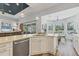 Bright kitchen features an island, stainless steel appliances, and opens to a living area and breakfast nook at 10082 Army Cir, Port Charlotte, FL 33981