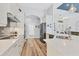 Bright kitchen features wood floors, modern stainless steel appliances, and white cabinets with black hardware at 10082 Army Cir, Port Charlotte, FL 33981