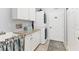 Functional laundry room with granite countertops, sink, ample cabinet space, and stacked washer and dryer at 10082 Army Cir, Port Charlotte, FL 33981