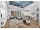 Well-lit living room featuring a dark blue ceiling and integrated kitchen views at 10082 Army Cir, Port Charlotte, FL 33981