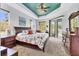 Spacious primary bedroom boasts a decorative ceiling, wood furniture, and access to the outdoor patio at 10082 Army Cir, Port Charlotte, FL 33981