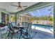 Enjoy the screened lanai with a dining set and access to the pool for outdoor entertaining at 10082 Army Cir, Port Charlotte, FL 33981