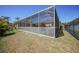 View of the backyard featuring the pool screen enclosure and fence, providing a serene outdoor living space at 10183 Winding River Rd, Punta Gorda, FL 33950