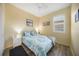 Cozy bedroom with neutral walls, wood-look floors and a bright window at 10183 Winding River Rd, Punta Gorda, FL 33950