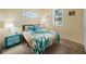 Bedroom featuring a bright window, wood-look flooring and nautical themed decor at 10183 Winding River Rd, Punta Gorda, FL 33950