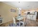 Bright dining area features a charming round table, chandelier lighting, and seamless access to the kitchen at 10183 Winding River Rd, Punta Gorda, FL 33950