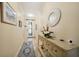 Inviting entryway with tile floors, decorative mirror, console table, and ornate front door at 10183 Winding River Rd, Punta Gorda, FL 33950