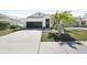 Charming single-story home featuring a two-car garage, landscaped yard, and well-maintained lawn at 10183 Winding River Rd, Punta Gorda, FL 33950