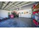 Spacious two-car garage with ample storage shelving, refrigerator, and white painted walls at 10183 Winding River Rd, Punta Gorda, FL 33950
