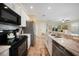 Bright kitchen with stainless steel appliances, granite countertops, and an open layout at 10183 Winding River Rd, Punta Gorda, FL 33950