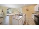 Modern kitchen featuring granite countertops, stainless steel appliances, and a breakfast bar at 10183 Winding River Rd, Punta Gorda, FL 33950