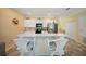 Open kitchen features white cabinets, stainless appliances, and counter seating at 10183 Winding River Rd, Punta Gorda, FL 33950
