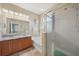 Elegant bathroom featuring double vanity, large soaking tub, glass-enclosed shower, and ample lighting at 10183 Winding River Rd, Punta Gorda, FL 33950