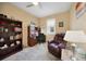 Cozy office features a ceiling fan, large bookshelf, writing desk, and comfortable leather recliner at 10183 Winding River Rd, Punta Gorda, FL 33950