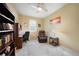 Comfortable office featuring a ceiling fan, large bookshelf, writing desk, and comfortable leather recliner at 10183 Winding River Rd, Punta Gorda, FL 33950