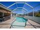 Relaxing screened-in pool featuring cool, clear water, patio seating, and seamless access to indoor and outdoor living at 10183 Winding River Rd, Punta Gorda, FL 33950