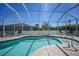 View of the sparkling pool area with a screened-in enclosure, providing a private and refreshing outdoor experience at 10183 Winding River Rd, Punta Gorda, FL 33950