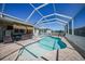 Backyard view of the screened-in pool showcasing outdoor lounging and dining space for comfortable entertaining at 10183 Winding River Rd, Punta Gorda, FL 33950