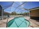 Backyard swimming pool area with a screened enclosure, offering a serene outdoor space for relaxation and enjoyment at 10183 Winding River Rd, Punta Gorda, FL 33950