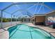 Sparkling screened-in pool area with comfortable seating and sunny skies, perfect for relaxation and outdoor fun at 10183 Winding River Rd, Punta Gorda, FL 33950