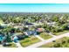 An aerial view of a residential neighborhood with tree-lined streets and well-maintained lawns at 10299 Willmington Blvd, Englewood, FL 34224