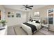 Comfortable bedroom with a queen-size bed, two windows for natural light, and neutral-toned walls at 10299 Willmington Blvd, Englewood, FL 34224