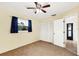 Bedroom with neutral walls, ceiling fan, closet, and natural light at 10299 Willmington Blvd, Englewood, FL 34224