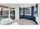 Sunny dining area with bay windows, sliding glass doors, and stylish blue accent walls at 10299 Willmington Blvd, Englewood, FL 34224