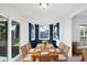 Bright dining area features white walls, blue accents, and a glass door to outdoor view at 10299 Willmington Blvd, Englewood, FL 34224