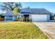 Charming single-story home boasts a well-manicured lawn, palm tree, and a two-car garage at 10299 Willmington Blvd, Englewood, FL 34224