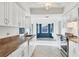 Spacious kitchen with white cabinets, modern appliances, and a view into the dining area at 10299 Willmington Blvd, Englewood, FL 34224